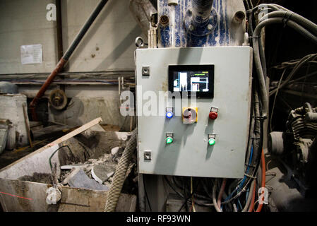 drilling machine. a factory worker operates a woodworking machine. Dashboard in production Stock Photo