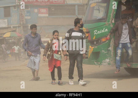 DHAKA, BANGLADESH - JANUARY 23 : Dust pollution reaches an alarming stage in Dhaka and many deaths as well as several million cases of illness occur every year due to the poor air quality in Dhaka, Bangladesh on January 23, 2019.   Dust kicked up by vehicles traveling on roads may make up 33% of air pollution. Road dust consists of deposits of vehicle exhausts and industrial exhausts, particles from tire and brake wear, dust from paved roads or potholes, and dust from construction sites. Road dust is a significant source contributing to the generation and release of particulate matter into the Stock Photo