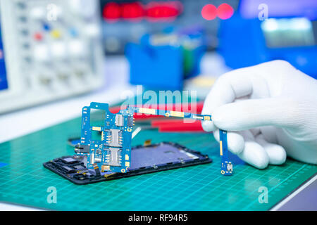 Fix of mobile phone in lab Stock Photo