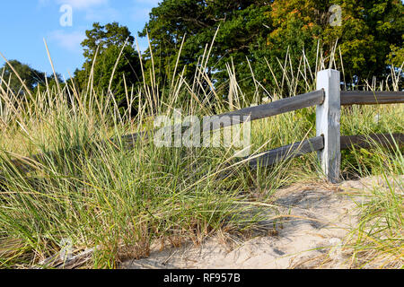 rustic weathered fence in dune grass on Michigan sand dune Stock Photo