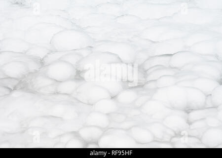 frozen clumps of white snow and ice on ground background Stock Photo