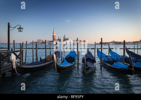Gondolas moored in front of the church of San Giorgio Maggiore, Venice, Italy Stock Photo