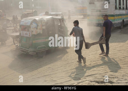 DHAKA, BANGLADESH - JANUARY 23 : Dust pollution reaches an alarming stage in Dhaka and many deaths as well as several million cases of illness occur every year due to the poor air quality in Dhaka, Bangladesh on January 23, 2019.   Dust kicked up by vehicles traveling on roads may make up 33% of air pollution. Road dust consists of deposits of vehicle exhausts and industrial exhausts, particles from tire and brake wear, dust from paved roads or potholes, and dust from construction sites. Road dust is a significant source contributing to the generation and release of particulate matter into the Stock Photo