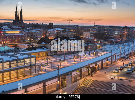 View over central Uppsala at the railway station in the winter at sunset. Uppsala, Sweden, Scandinavia. Stock Photo
