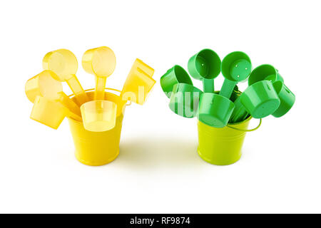Green and yellow plastic spoons in small buckets. Isolated on white background. Stock Photo