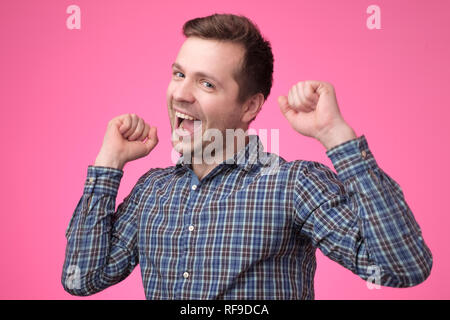 Happy young european man gesturing and smiling Stock Photo