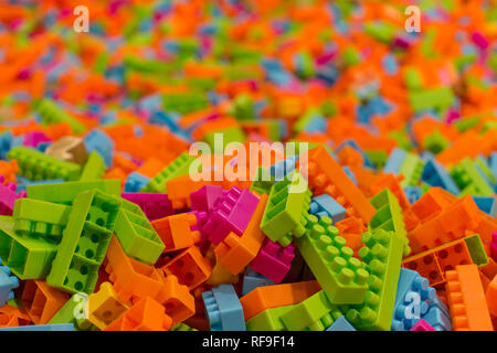 Children play area, kid's corner with a lot of toys and toy blocks and bricks very colorful scene with focus on toys and background out of focus Stock Photo