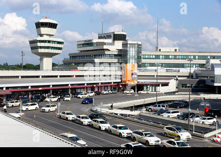 BERLIN - JUN 1, 2016: Airport tower and taxi s in front of the airport terminal of Berlin-Tegel airport. Stock Photo