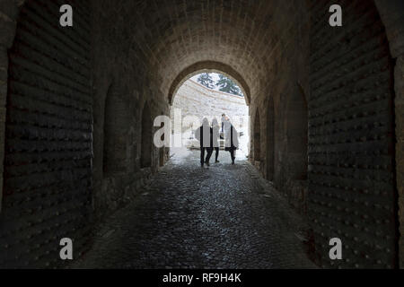 Belgrade, Serbia, January 2019 - Group of tourists passing an archway entrance to the Kalemegdan Fortress Stock Photo