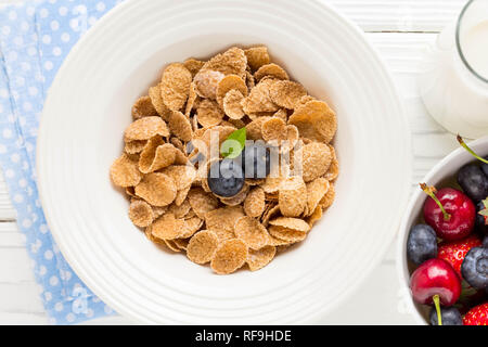 Multi-slag flakes for Breakfast with berries and milk, muesli, corn Stock Photo