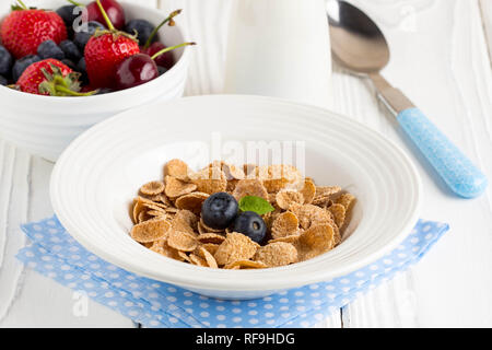 Multi-slag flakes for Breakfast with berries and milk, muesli, corn Stock Photo