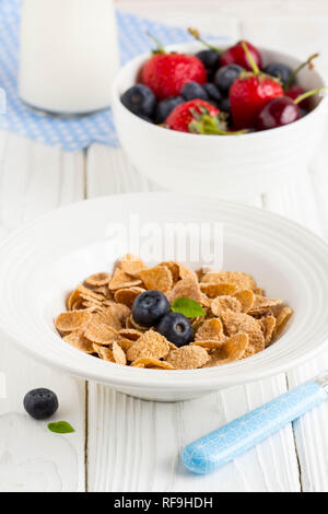 Multi-slag flakes for Breakfast with berries and milk, muesli, corn Stock Photo