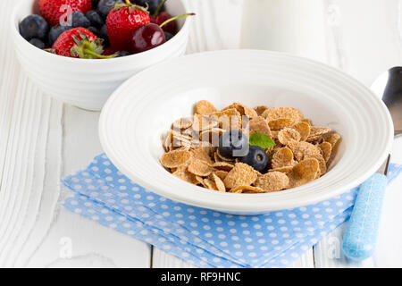 Multi-slag flakes for Breakfast with berries and milk, muesli, corn Stock Photo