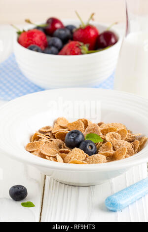 Multi-slag flakes for Breakfast with berries and milk, muesli, corn Stock Photo