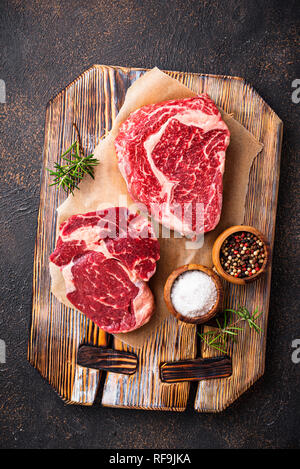 Raw marbled ribeye steak and spices Stock Photo
