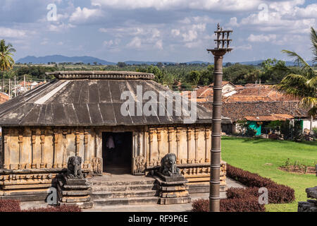 Belavadi, Karnataka, India - November 2, 2013: Veera Narayana Temple. The Entry hall in front of the sanctuary with the flagpole and elephant statues  Stock Photo