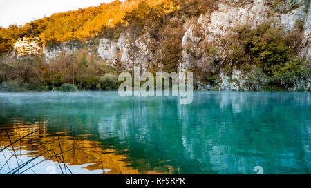 Misty Lake at dawn within the colorful Plitvice National Park in Croatia Stock Photo