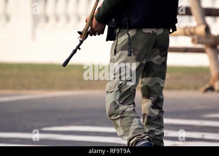 Security guard with rifle standing on outside to protect the area. Stock Photo