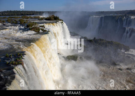 Tourists at Iguazu Falls, one of the world's great natural wonders, on the border of Brazil and Argentina Stock Photo