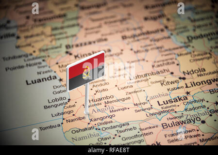 Angola marked with a flag on the map Stock Photo