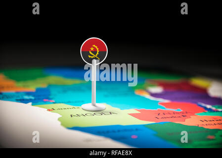 Angola marked with a flag on the map Stock Photo