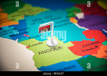 Angola marked with a flag on the map Stock Photo