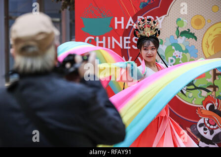 Berlin, Germany. 24th Jan, 2019. A visitor takes photos of a dancer in a shopping mall at Potsdamer Platz in Berlin, capital of Germany, on Jan. 24, 2019. 'Happy Chinese New Year,' a series of Chinese cultural celebrations for the upcoming Spring Festival, kicked off in downtown Berlin on Thursday. Credit: Shan Yuqi/Xinhua/Alamy Live News Stock Photo