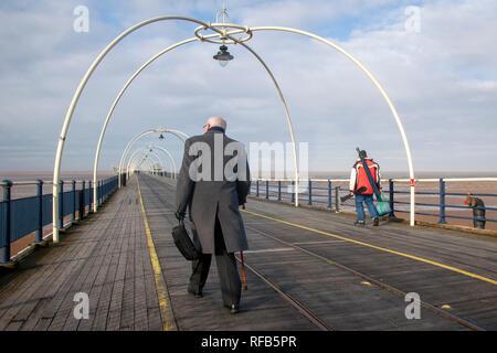Southport, Merseyside. 25th Jan, 2019. UK Weather. Brisk winds with sunshine & showers at the coastal resort as two men with different lifestyles ( angler & solicitor) enjoy the seaside attractions. Credit: MediaWorldImages/Alamy Live News Stock Photo
