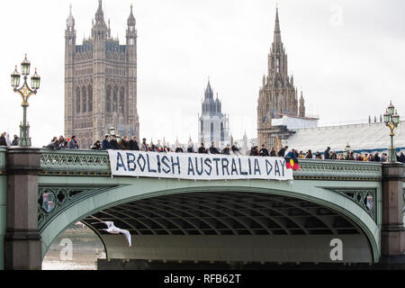 London, UK. 25th January, 2019. Activists drop a banner from Westminster Bridge, in view of the Houses of Parliament, to call for the abolition of Australia Day in advance of rallies in every Australian city tomorrow. The event was organised in solidarity with Aboriginal and Torres Strait Islander people who consider Australia Day, a day celebrating the colonisation of Australia, to be a day of mourning rather than a day of celebration. Credit: Mark Kerrison/Alamy Live News