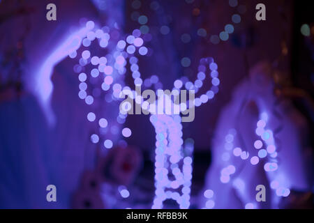 Blue blurred soft defocused lights background.Christmas winter holiday concept wallpaper. Abstract pairs of lover deer of blur silver and blue light b Stock Photo