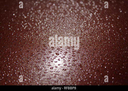 background with drops Drops of water on red and black surface Stock Photo