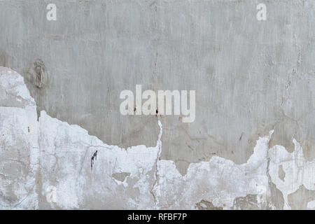 Full frame background of a weathered and cracked plastered gray concrete wall. Plaster is partly peeled off. Stock Photo