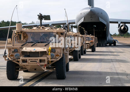 U.S. Army Soldiers and vehicles from the 3rd Special Forces Group prepare to board a Hawaii Air National Guard C-17 Globemaster III January 21, 2019, at Camp Shelby Joint Forces Training Center near Hattiesburg, Miss. The 204th Airlift Squadron transported personnel and vehicles to the Gulfport Combat Readiness Training Center, Miss., during exercise Southern Strike. The annual training is a is a total force, multi-service exercise hosted by the Mississippi Air National Guard’s Combat Readiness Training Center in Gulfport, and Camp Shelby Joint Forces Training Center near Hattiesburg, Miss. fr Stock Photo