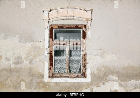 Weather worn wooden window on the house. Stock Photo