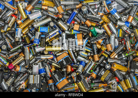 Colorful closeup detail of large pile of dead used single use disposable batteries from various manufacturers, Vancouver, Canada. Stock Photo