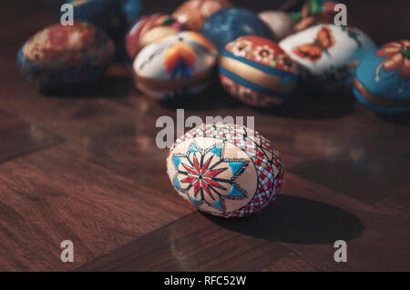 Painted colorful easter eggs on wooden table Selective focus Stock Photo