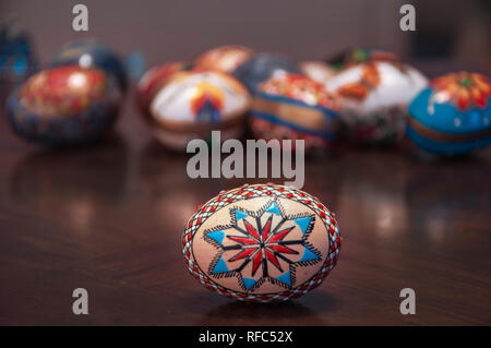 Painted colorful easter eggs on wooden table Selective focus Stock Photo
