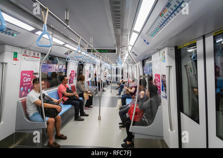 Singapore - January 2019: Passengers in Singapore Mass Rapid Transit (MRT) train. The MRT has 102 stations,  the second-oldest metro system in SEA Stock Photo