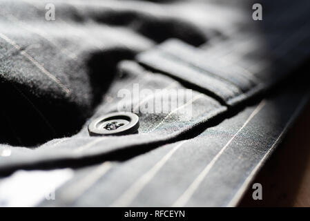 Black button on trousers Stock Photo