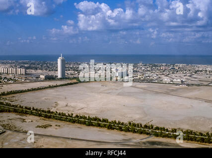 Dubai. Aerial view of Dubai with the Dubai Trade Centre Tower looking out over Satwa to the Jumeirah Mosque with its twin minarets towards the coast in 1986 Stock Photo