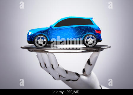 Close-up Of A Robot Holding Car On Tray With Polygonal Pattern Over Grey Background Stock Photo