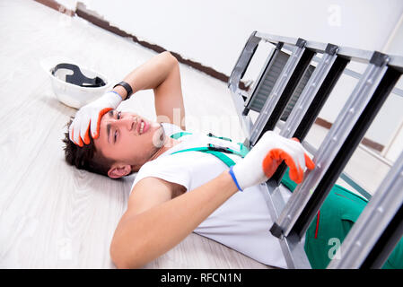 Young worker falling from the ladder Stock Photo