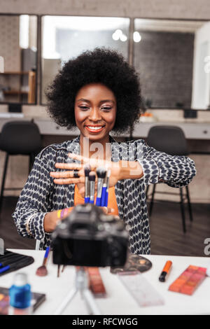 African american woman with curly hair looking amused Stock Photo
