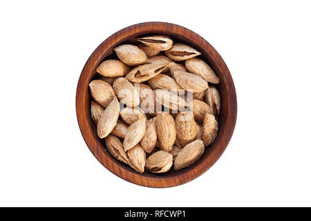 Unpeeled almonds Badam in a wooden cedar plate on a white isolated background. Row of bowls with almonds Badam, top view. Unpeeled almonds Badam patte Stock Photo
