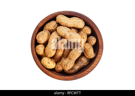 Unpeeled peanuts in a wooden cedar plate on a white isolated background. Row of bowls with peanuts, top view.  Unpeeled peanuts pattern Stock Photo