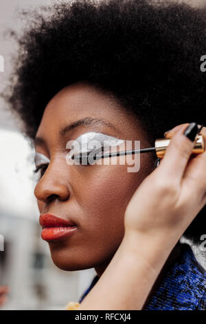 Dark-haired beautiful model with bright lips feeling concentrated Stock Photo