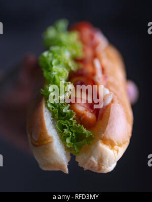 Woman holding hot dog Stock Photo
