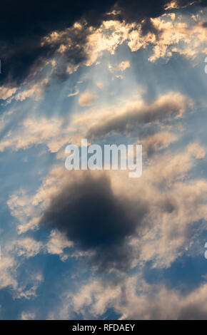 The sun shines through the clouds Stock Photo