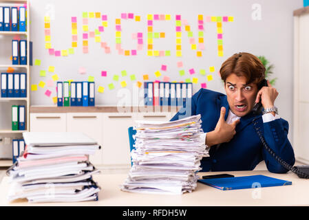 Young employee suffering from excessive work Stock Photo