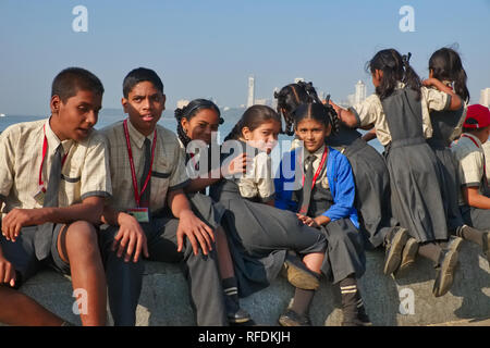 School children in Mumbai, India, relaxing at Marine Drive by the Arabian Sea Stock Photo